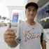 Cuban American Luis Azcuy, of Hialeah, Fla., stands outside of Marlins Park with his tickets before a baseball game between the Miami Marlins and Houston Astros, Friday, April 13, 2012, in Miami. Azcuy is a season ticket holder, but was offended by remarks made by manager Ozzie Guillen in which he expressed admiration for Cuban leader Fidel Castro. Azcuy is in support of Guillen losing his job. Guillen was suspended for five games. (AP Photo/Lynne Sladky)