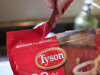 FILE - In this May 8, 2011 photo, Jamey Boccio opens a bag of frozen Tyson Chicken Nuggets at her home in Palo Alto, Calif. Tyson Foods is reporting a fall in earnings growth for its third quarter Monday, Aug. 8, 2011, but the results beat expectations on higher pork profits. (AP Photo/Paul Sakuma, File)