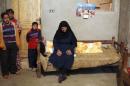 Younan, mother of Ayyad, one of 27 Egyptian Coptic Christian workers kidnapped in the Libyan city of Sirte, sits on the bed at the family's house in Al-Our village, in Minya governorate