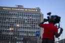 A cameraman films the Geneva University Hospital where US Secretary of State John Kerry receives treatment, late on May 31, 2015
