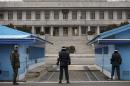 North Korean soldier stands on top of the stairs, as South Korean soldiers stand guard below at the truce village of Panmunjom in the demilitarised zone dividing the two Koreas, in Paju