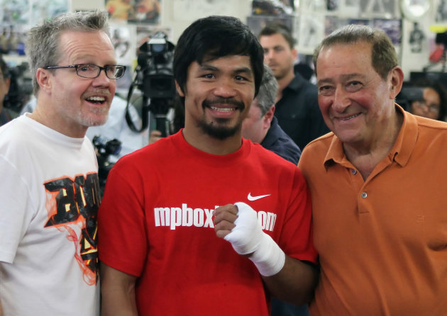 Freddie Roach, Manny Pacquiao and Bob Arum. (Getty Images)
