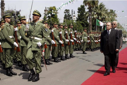 Algeria's President and head of the Armed Forces Abdelaziz Bouteflika reviews an honour guard upon his arrival to attend a graduation ceremony of the 40th class of the trainees army officers at a Military Academy in Cherchell