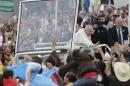 Pope Francis waves to the crowd as he rides aboard the Popemobile in streets of Quito, Ecuador, Sunday, July 5, 2015. Francis is making his first visit as pope to his Spanish-speaking neighborhood. He'll travel to three South American nations, Ecuador, Bolivia and Paraguay, which are beset by problems that concern him deeply, income inequality and environmental degradation. (AP Photo/Dolores Ochoa)