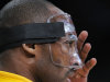 Los Angeles Lakers guard Kobe Bryant adjusts his protective mask prior to the Lakers' NBA basketball game against the Minnesota Timberwolves, Wednesday, Feb. 29, 2012, in Los Angeles. Bryant broke his nose during the All-Star game. (AP Photo/Mark J. Terrill)