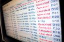 A display shows cancelled flights at the Delta Airlines terminal at New York's LaGuardia Airport during a powerful winter storm in New York City