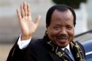 Cameroon's President Paul Biya waves as he leaves following a meeting at the Elysee Palace in Paris