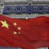 A Chinese national flag flies in front of COSCO's headquarters in Beijing