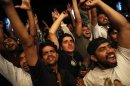 Supporters of the Pakistan Muslim League - Nawaz celebrate in front of a party office as results of the general election come in, in Lahore