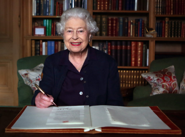 Embargoed to 0001 Wednesday October 9. Previously unreleased photo dated 27/09/2013 of Queen Elizabeth II sitting at a desk at Balmoral, Royal Deeside, as she signs a message that will travel in the Glasgow 2014 Baton as it is carried throughout the Commonwealth ahead of the Glasgow 2014 Commonwealth Games.