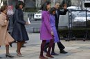 President Barack Obama, accompanied by his daughters Sasha and Malia, first lady Michelle Obama and mother-in-law Marian Robinson, waves as they arrive at St. John's Church in Washington, Monday, Jan. 21, 2013, for a church service during the 57th Presidential Inauguration. (AP Photo/Jacquelyn Martin)