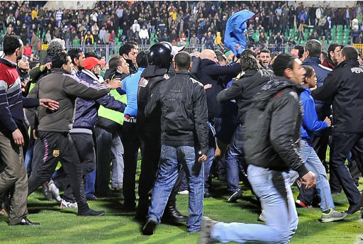 Egyptian football fans rush during riots that erupted after a football match