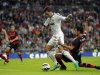Real Madrid's Ozil is fouled by Celta Vigo's Cabral during their Spanish First Division soccer match at Santiago Bernabeu stadium in Madrid