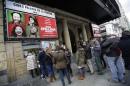 People stand in line to buy tickets for film "8 Apellidos Vascos" at a cinema in central Madrid