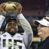 Oregon's Michael Clay, left, holds up the championship trophy as head coach Chip Kelly looks on after the Fiesta Bowl NCAA college football game against Kansas State Thursday, Jan. 3, 2013, in Glendale, Ariz.  Oregon defeated Kansas State 35-17.(AP Photo/Ross D. Franklin)