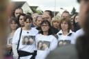 People gather outside the victims' house during a march in the Paris suburb of Magnanville, on June 16, 2016, in tribute to a French policeman and his partner who were knifed to death by an extremist