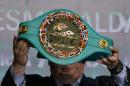 Mauricio Sulaiman, president of the World Boxing Council, holds up the "Cinturon Esmeralda" or Emerald Belt, during a media presentation, in Mexico City, Tuesday, April 21, 2015. The title belt will be awarded to the winner of the WBC world championship superfight between Floyd Mayweather and current WBO welterweight champion Manny Pacquiao in Las Vegas on May 2. (AP Photo/Rebecca Blackwell)