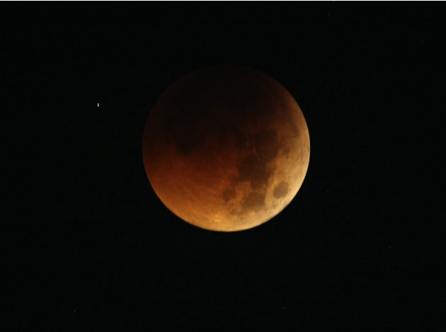 The Earth completely casts its shadow over the moon in a total lunar eclipse as seen in Manila, Philippines before dawn Thursday June 16, 2011. The total lunar eclipse was also visible in most parts o