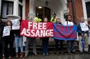 Protesters hold banners that read "Free Assange" outside the Ecuadorian Embassy in London on November 14, 2016