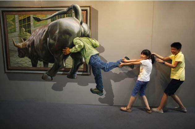 Kids pose for a photograph in front of a 3D painting at 2012 Magic Art Special Exhibition in Hangzhou