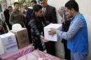 Displaced Iraqi Sunnis fleeing from Islamic State militants in al-Baghdadi district in Anbar provinces, receive aid from the United Nations Refugee Agency (UNHCR) in Baghdad