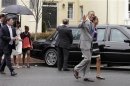 U.S. President Obama waves as he walks with first lady Michelle Obama and their daughters after attending Easter service at St. John's Episcopal Church in Washington