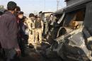 Security forces inspect the site of car bomb attack in Baghdad's Sadr city