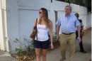 Cuban exile Sergio Dalmau, right, walks on the sidewalk with his daughter Cecilia as they search for the childhood home of his ex-wife, Cecilia's mother, in the Miramar suburb in Havana, Cuba, Tuesday March 27, 2012. Dalmau left Cuba 51 years ago Thursday as part of the so-called 