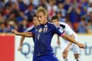 Japan's Keisuke Honda prepares to kick the ball to score a goal from the penalty spot during the AFC Asia Cup soccer match between Iraq and Japan in Brisbane, Australia, Friday, Jan. 16, 2015. (AP Photo/Tertius Pickard)