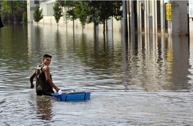 A worker retrieves items from a factory in the flood waters of the Passaic River days after the passing of Hurricane Irene in Paterson