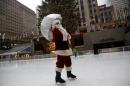 A man dressed as Santa Claus ice skates at The Rink At Rockefeller Center on Christmas Eve in Manhattan, New York City, U.S.