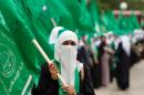 Palestinian supporters of the Islamic Hamas movement attend a rally on the outskirts of Ramallah in the West Bank on May 6, 2014