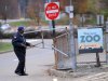A security guard closes the gate at the Pittsburgh Zoo, where zoo officials say a young boy was killed after he fell into the exhibit that was home to a pack of African painted dogs, who pounced on the boy and mauled him, Sunday, Nov. 4, 2012. It’s not clear whether he died from the fall or the attack, said Barbara Baker, president and CEO of the Pittsburgh Zoo & PPG Aquarium. (AP Photo/John Heller)