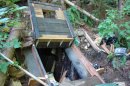 This undated photo provided by the King County Sheriff's Department on Friday, April 27, 2012, shows a bunker that deputies say belongs to a man suspected of killing his wife and daughter and holing up for days in the Cascade foothills east of Seattle. King County Sheriff's Sgt. Cindi West says authorities pumped gas into the underground bunker and they believe someone is inside. (AP Photo/King County Sheriff's Department)