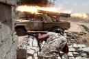 Libyan forces allied with the U.N.-backed government fire weapons during a battle with IS fighters in Sirte,