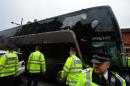 The bus carrying the Manchester United team is escorted by police after having a window smashed on its way to West Ham's Boleyn ground before the English Premier League football match in east London on May 10, 2016