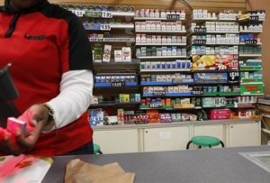 Cigarettes are displayed behind the counter of a convenient …
