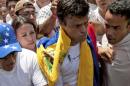 FILE - In this Feb 18, 2014 file photo, opposition leader Leopoldo Lopez, second from right, draped in a Venezuelan national flag, is flanked by Jose Rafael Perez, right, just before Lopez surrenders to national guards, in Caracas, Venezuela. Jose Rafael Perez is one of the young men arrested in the grisly slaying of a woman that has become yet another political flashpoint in hyper-polarized Venezuela, with supporters and opponents of the Nicolas Maduro administration each saying the killers were working for the other side. (AP Photo/Juan Manuel Hernandez, File)