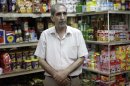 Abdul Hadi al-Obeidi, 65, a Sunni Muslim and is married to a Shiite woman who manages a grocery store in the Karrada Neighborhood of Baghdad, Iraq, poses for a portrait Wednesday, July 4, 2012. "Every time I leave my house, I don't know what will happen to me. I can only leave it in God's hands," he said. (AP Photo/Khalid Mohammed)