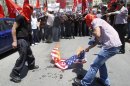 Palestinians burn an American flag during a rally to demand better conditions for Palestinian prisoners in Israeli jails, in Nablus, West Bank, Saturday, May 12, 2012. (AP Photo/Nasser Ishtayeh)
