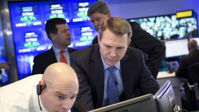 Jay Heller, left, IPO Execution Officer for Nasdaq, shows Keith Dunleavy, CEO of Inovalon, the progress of pricing for his company&#39;s stock on computer screens during the Bowie, Maryland health-tech firm&#39;s IPO at the Nasdaq MarketSite, Thursday, Feb. 12, 2015 in New York.  Stocks rose in early trading Thursday as energy and technology stocks climbed. (AP Photo/Mark Lennihan)