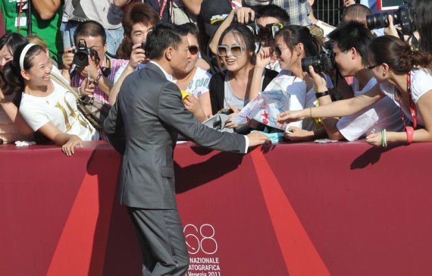 Hong Kong actor Andy Lau signs autographs as he arrives for the screening of "Tao Jie (A simple life)"