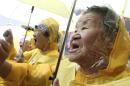 FILE - In this Wednesday, Aug. 12, 2009 file photo, former comfort women who served the Japanese Army as sexual slaves during World War II, shout a slogan in a rally before Korean Liberation Day of Aug. 15, which marks the end of Japanese colonial rule in 1945, in front of the Japanese Embassy in Seoul, South Korea. Japanese lawmakers met behind closed doors Friday to hear results of a probe into a study that was the basis of Japan's 1993 apology over its use of wartime sex slaves - a review that South Korea and China have slammed as an attempt to discredit historical evidence of such abuses. (AP Photo/Ahn Young-joon, File)