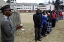 People wait to cast their votes in Mbare township outside Harare