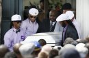 Pallbearers carry the casket of Odin LLoyd following a funeral ceremony at the Church of the Holy Spirit in Boston in Boston, Saturday, June 29, 2013. Hundreds of relatives, friends and well-wishers wept together and hugged at the funeral for LLoyd, a semi-pro football player whose killing led to murder and weapons charges against former New England Patriots player Aaron Hernandez. (AP Photo/Michael Dwyer)