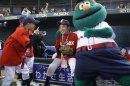 Children play with Boston Red Sox mascot before a baseball clinic in Tokyo