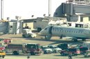 This photo from video provided by WLS-TV in Chicago shows fire and ambulance crews on the runway at Midway Airport after reports of a medical emergency that led to the quarantine of a Delta airplane Thursday, April 26, 2012, in Chicago. (AP Photo/WLS-TV) TELEVISION OUT