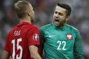 Poland goalkeeper Lukasz Fabianski, right, and Poland's Kamil Glik, celebrate at the end of the Euro 2016 Group C soccer match between Germany and Poland at the Stade de France in Saint-Denis, north of Paris, France, Thursday, June 16, 2016. The match ended in a 0-0 draw. (AP Photo/Christophe Ena)