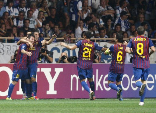 Barcelona's Lionel Messi celebrates his goal against Porto with teammates during their European Super Cup soccer match at Louis II stadium in Monaco