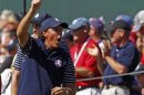 U.S. golfer Mickelson cheers as he watches Watson and Simpson play on the 17th green during the morning foursomes round at the 39th Ryder Cup matches at the Medinah Country Club